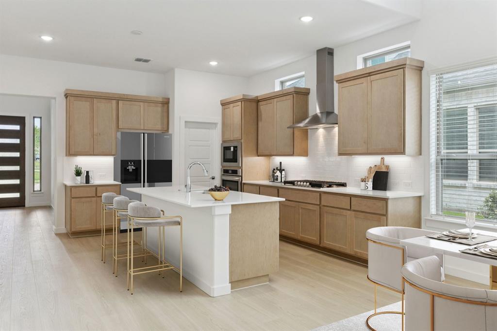 1904 Palmetto Road Celina, TX 75009 - Photo 7 of 32 a kitchen with appliances a sink cabinets and a counter top space