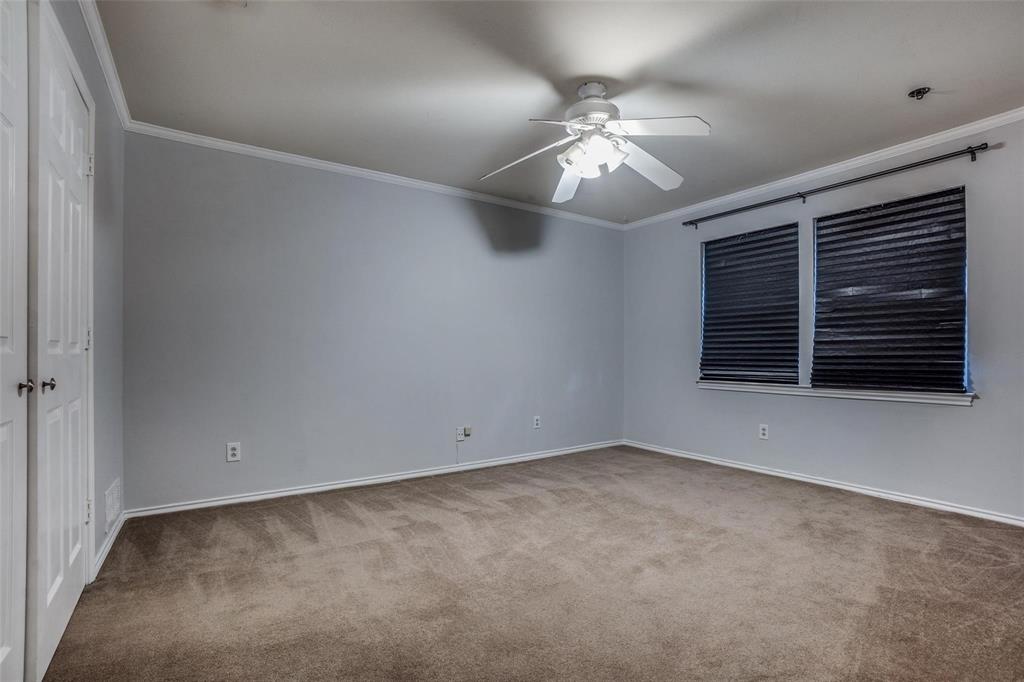 9911 Silver Creek Road Dallas, TX 75243 - Photo 20 of 28 Carpeted room featuring a ceiling fan with integrated lighting, crown molding, and two windows with blinds