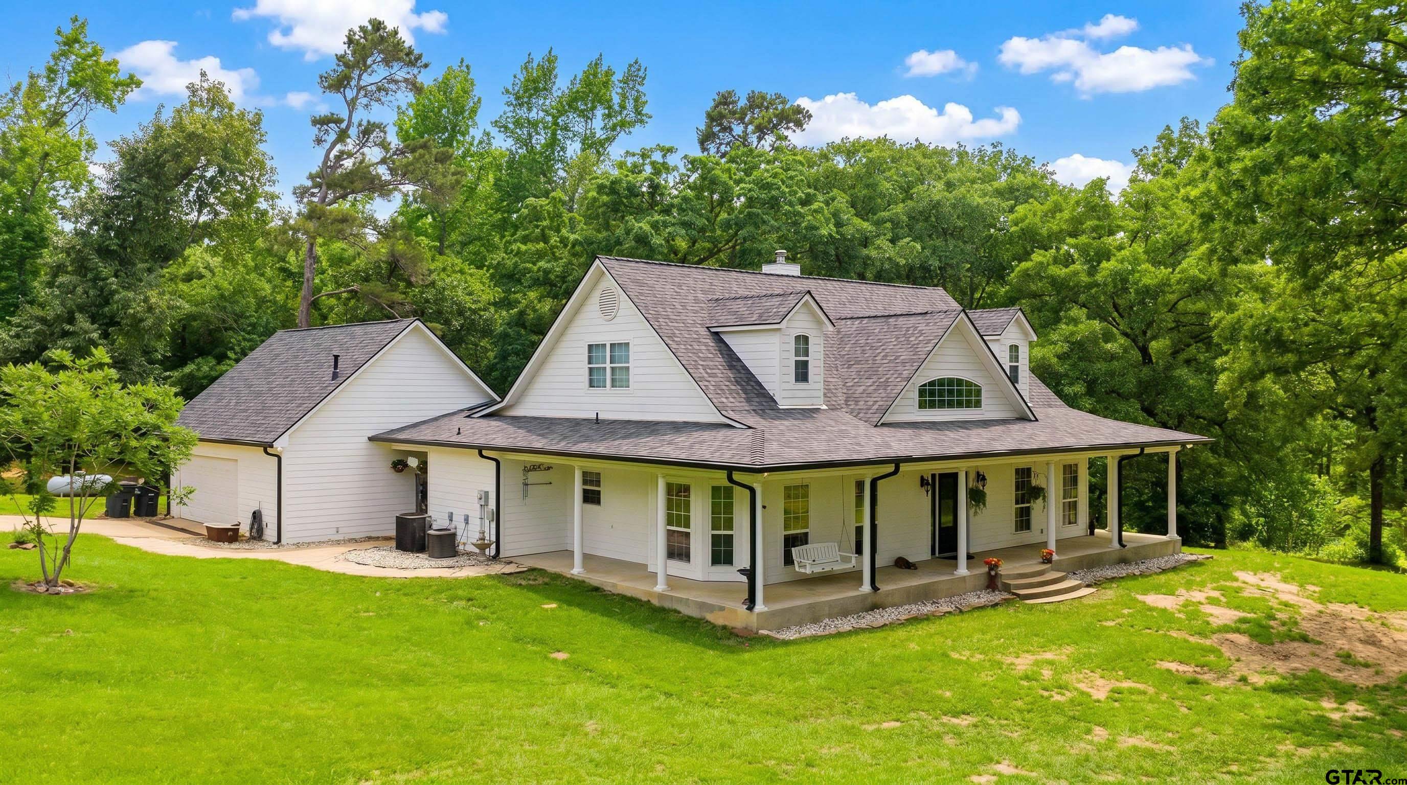 1776 Mustang Road Gilmer, TX 75645 - Photo 4 of 45 a view of a house with a yard and sitting area
