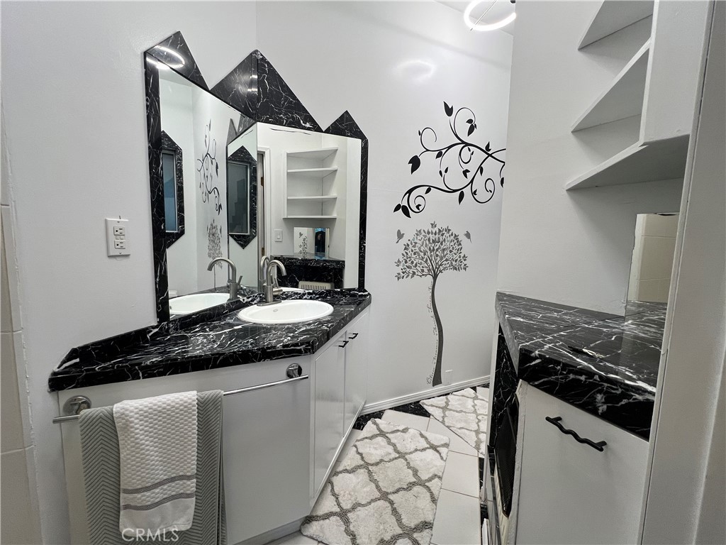 9400 McKinley Road Kelseyville, CA 95451 - Photo 18 of 31 a bathroom with a granite countertop sink a stove and a mirror