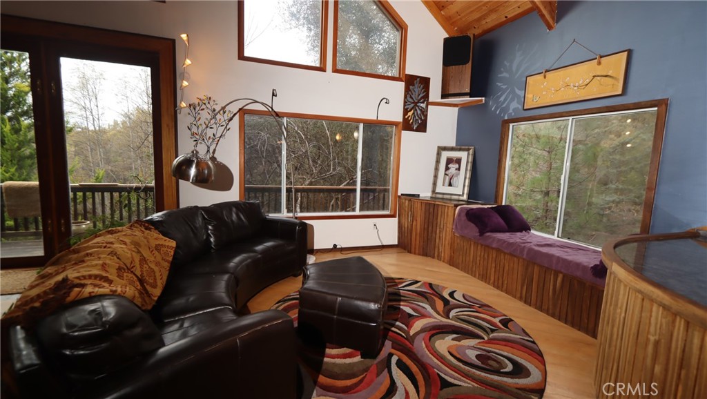 9400 McKinley Road Kelseyville, CA 95451 - Photo 3 of 31 a living room with furniture and a floor to ceiling window