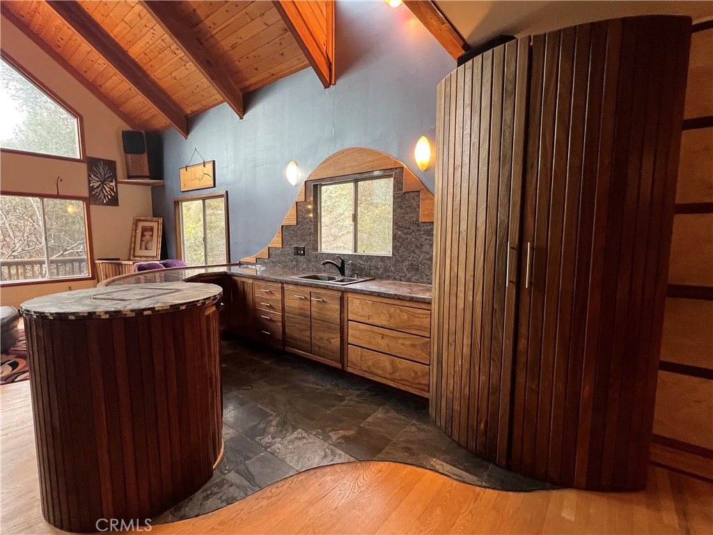 9400 McKinley Road Kelseyville, CA 95451 - Photo 4 of 31 a kitchen with a sink and wooden cabinets