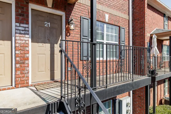 a view of a balcony with furniture and floor to ceiling window