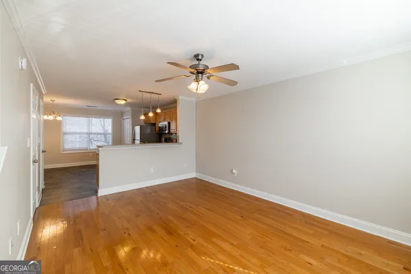 an empty room with fan and entrance