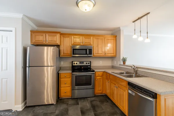 a kitchen with a sink stainless steel appliances and cabinets
