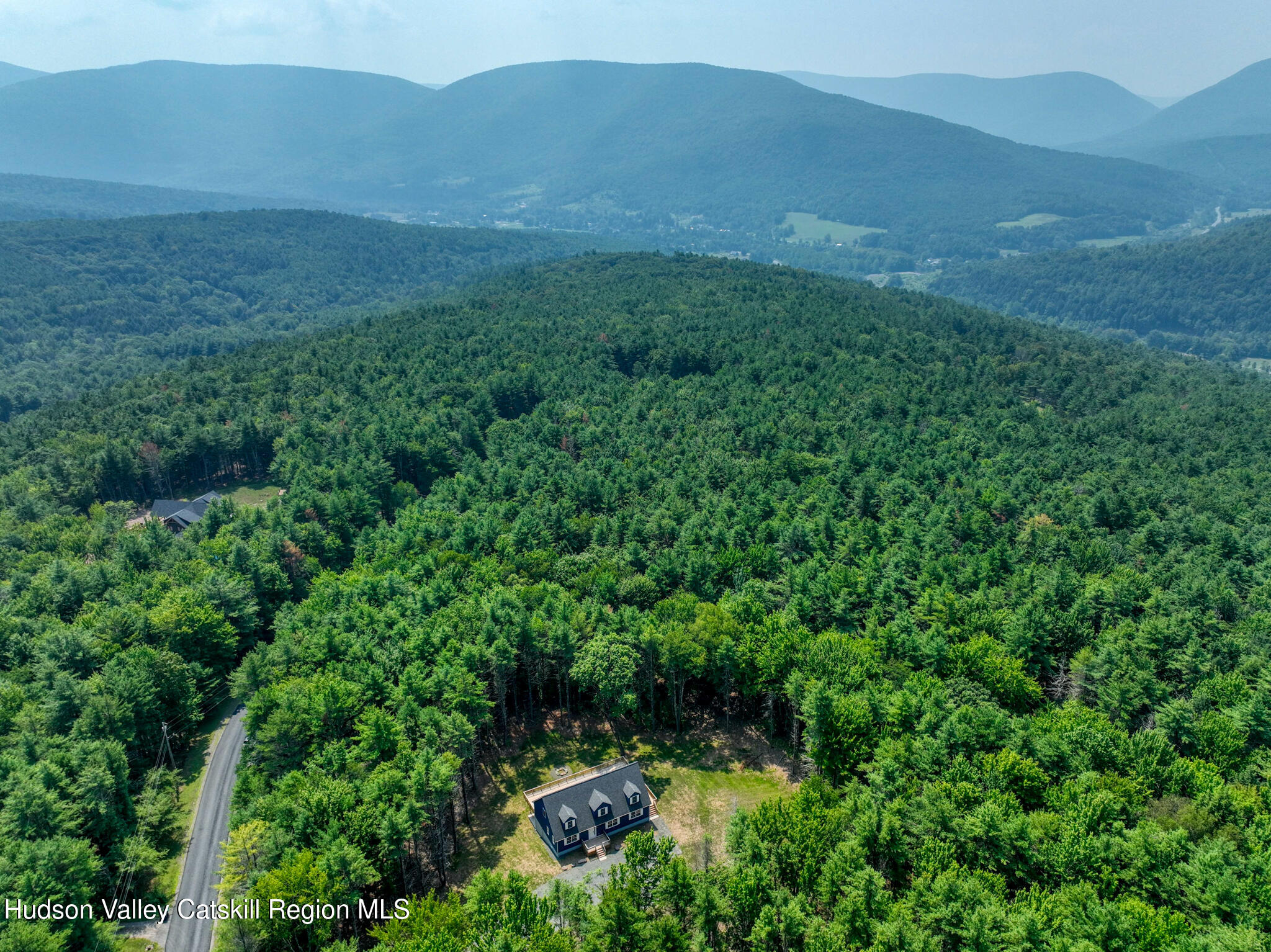 a view of a lush green hillside and a building