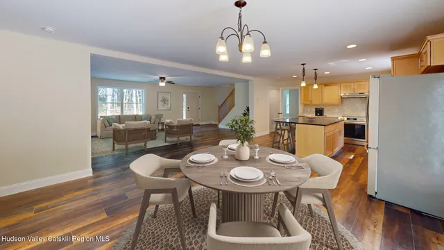 a view of a dining room with furniture and wooden floor