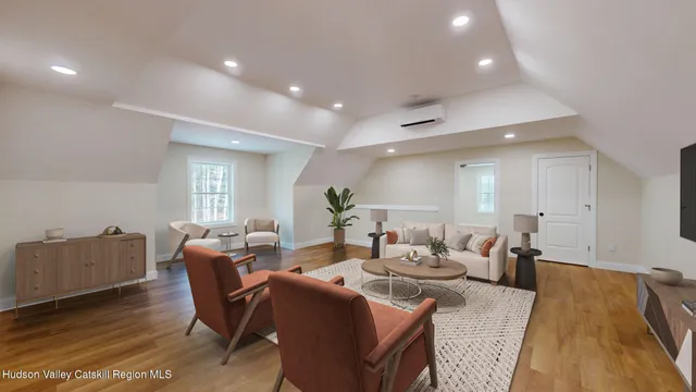 a living room with furniture a wooden floor and a chandelier