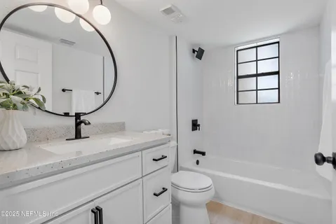 a large bed sitting in a bedroom next to a window