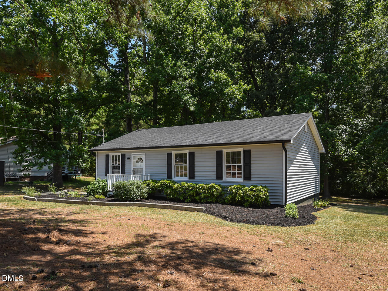 939 Cheves Road Zebulon, NC 27597 - Photo 1 of 21 a front view of a house with a yard and garage