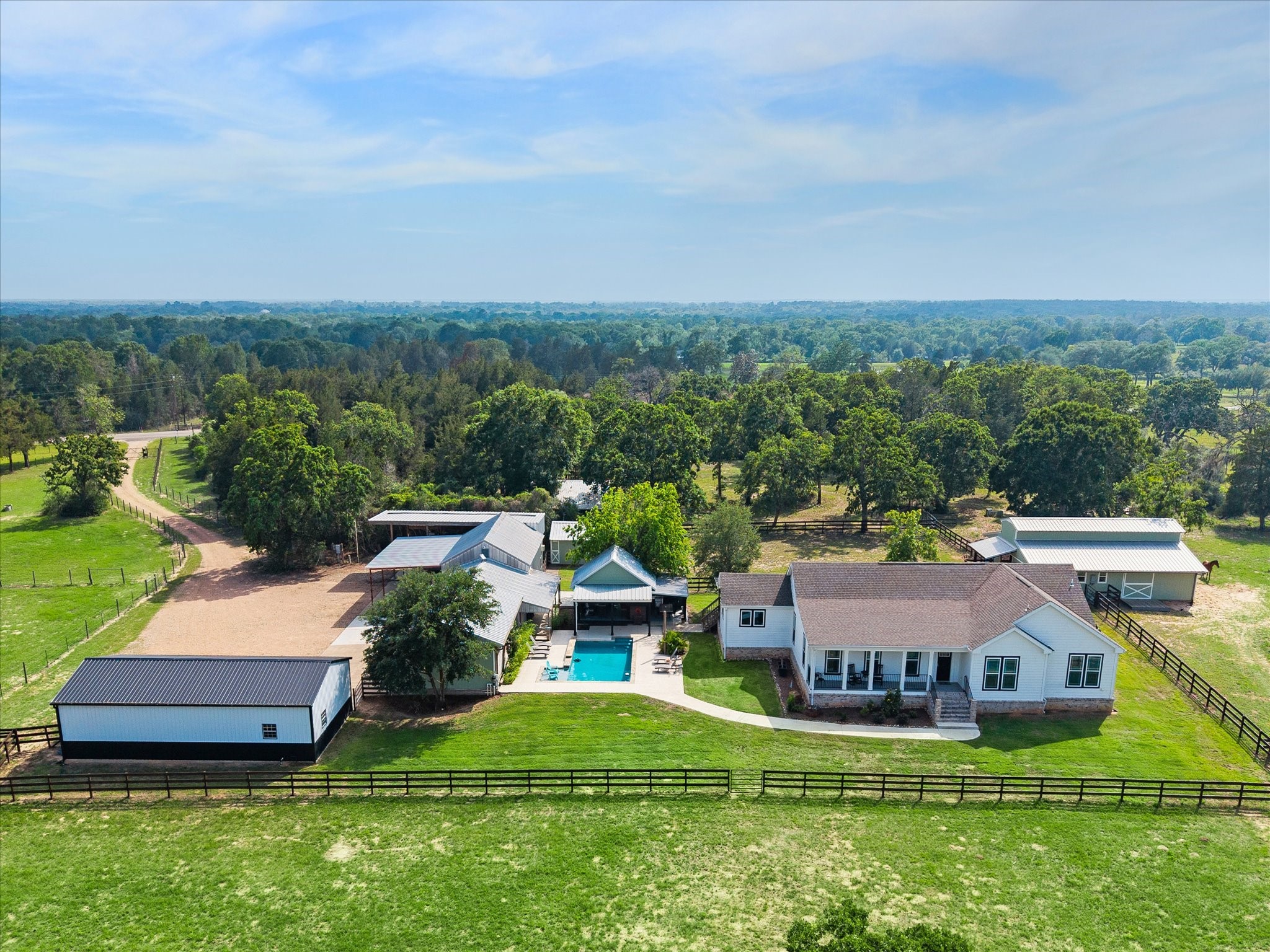 15946 Farm To Market Road 1094 Cat Spring, TX 78933 - Photo 1 of 50 an aerial view of a house with a garden and lake view