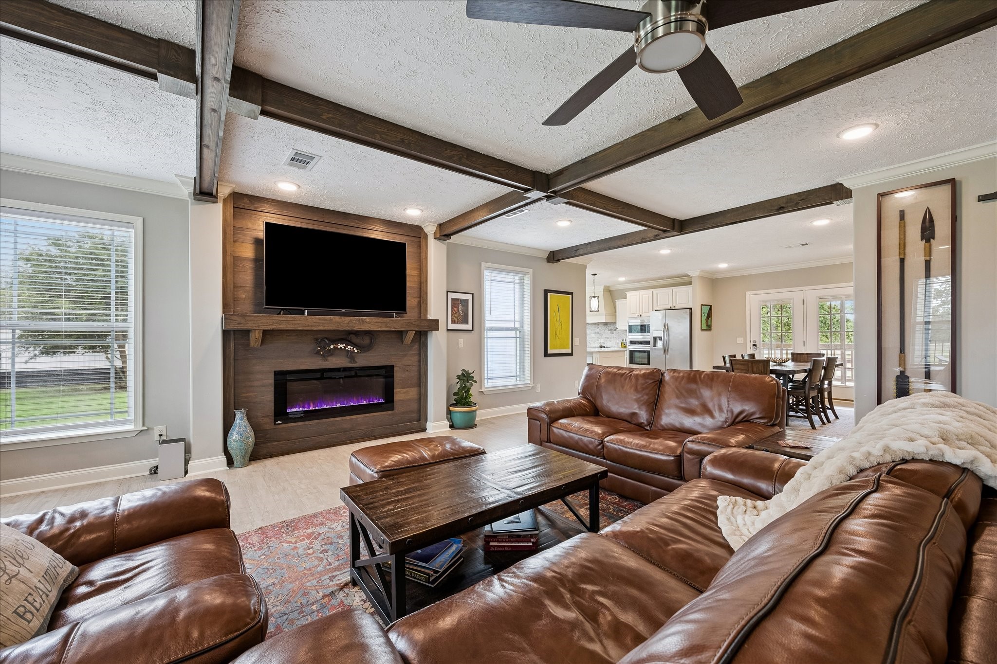 15946 Farm To Market Road 1094 Cat Spring, TX 78933 - Photo 12 of 50 a living room with furniture a fireplace and a flat screen tv