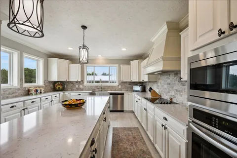 a kitchen with counter top space a stove and cabinets