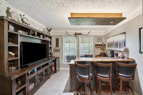 a kitchen with granite countertop a table and chairs in it