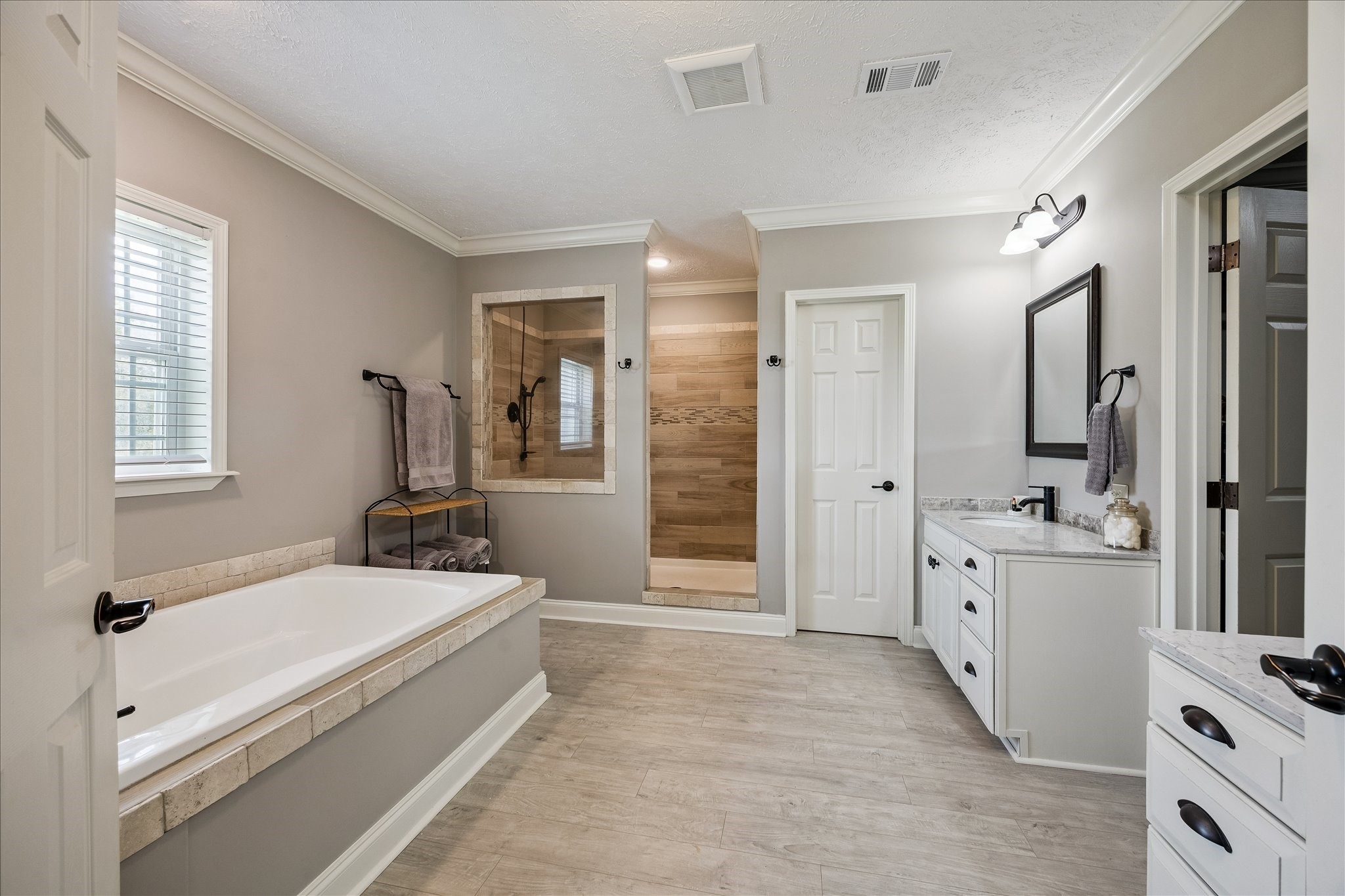 15946 Farm To Market Road 1094 Cat Spring, TX 78933 - Photo 19 of 50 a spacious bathroom with a tub sink and mirror