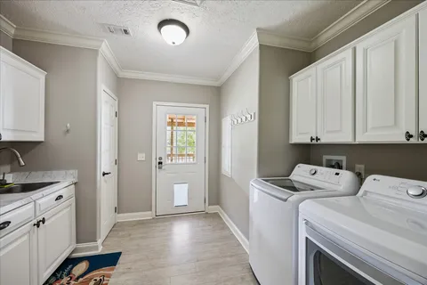 a view of a kitchen with sink and cabinets