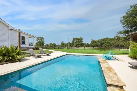 a view of a patio with swimming pool