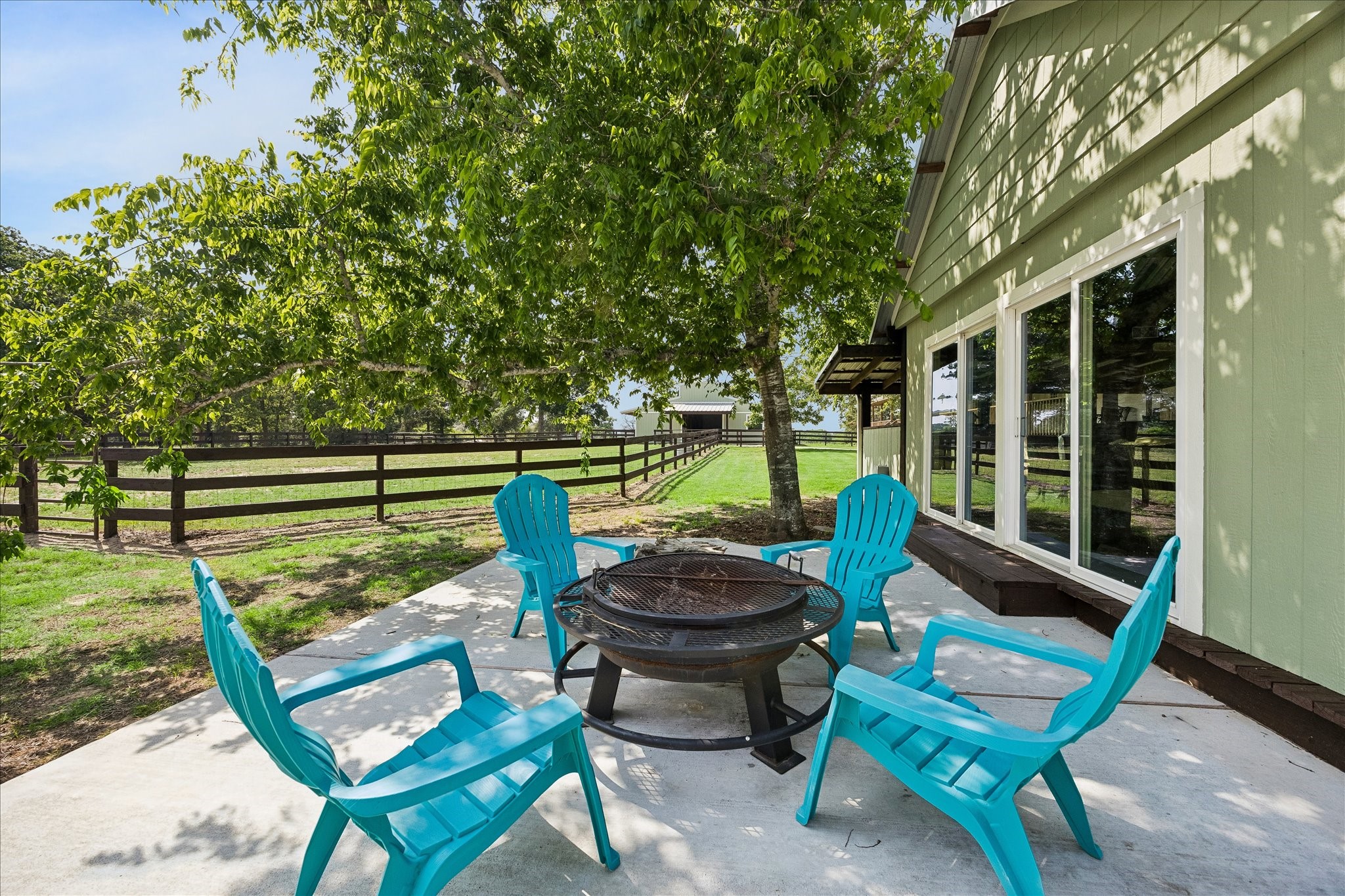 15946 Farm To Market Road 1094 Cat Spring, TX 78933 - Photo 36 of 50 a view of a chair and tables in the backyard