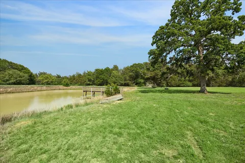 a view of a lake with houses in the back
