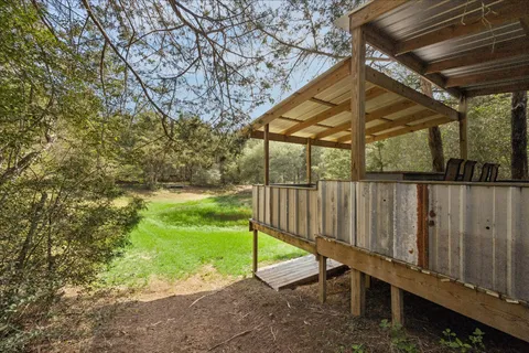 a view of backyard with wooden fence