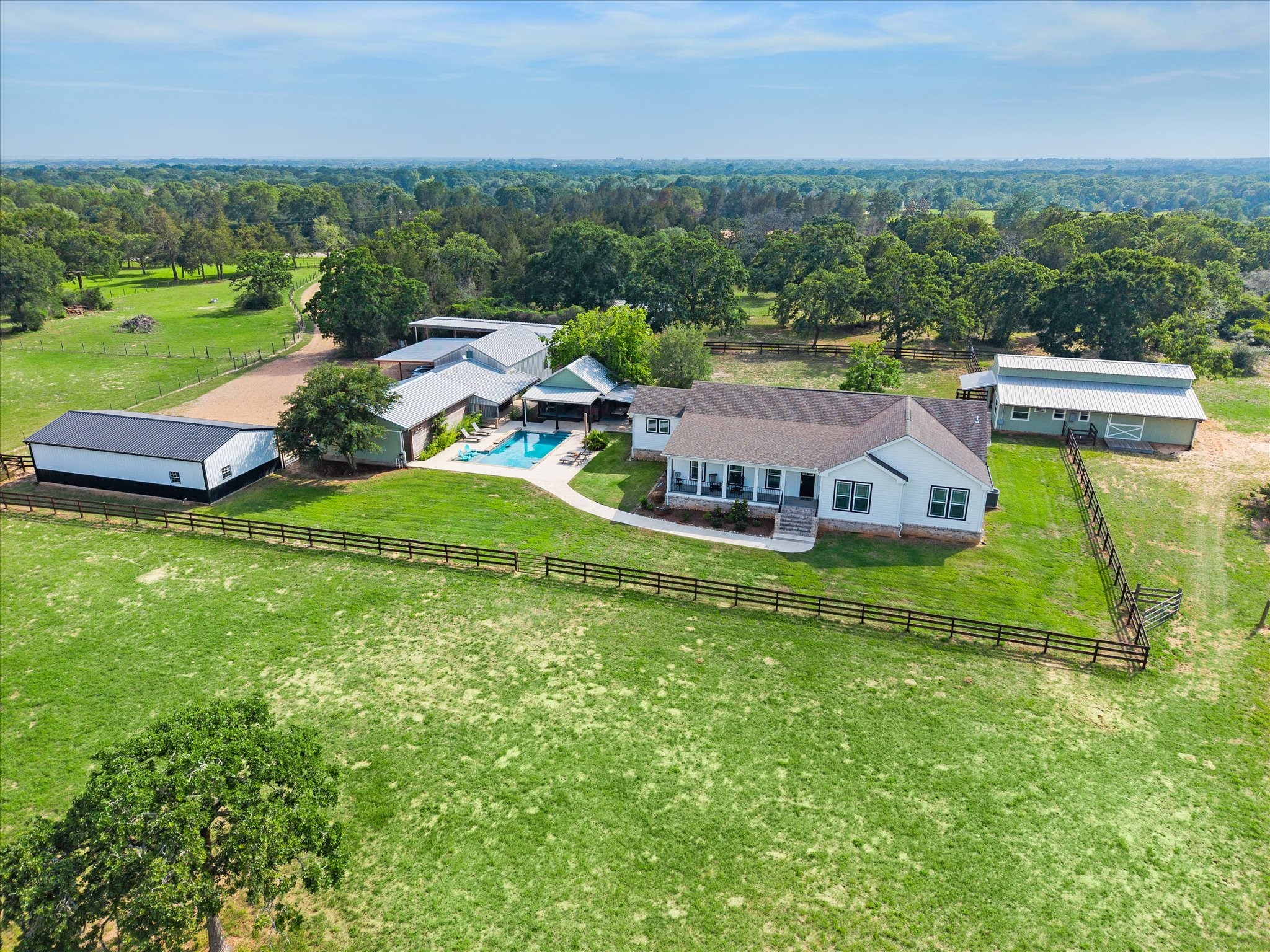 15946 Farm To Market Road 1094 Cat Spring, TX 78933 - Photo 4 of 50 an aerial view of a house with pool big yard and large trees