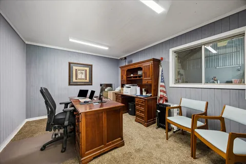 a work room with furniture and a window