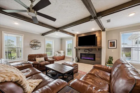 a living room with furniture fireplace and a flat screen tv