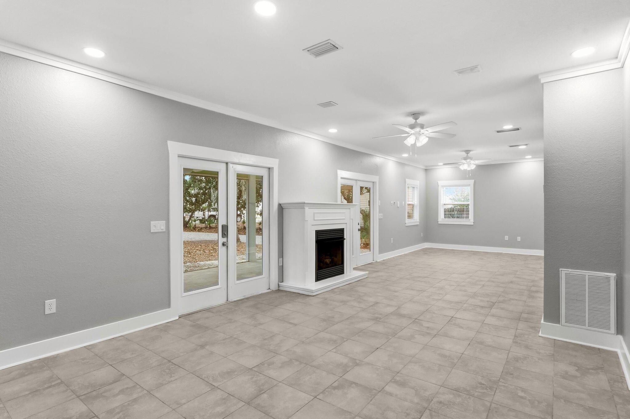 128 Bay Magnolia Lane Santa Rosa Beach, FL 32459 - Photo 13 of 61 an empty room with windows and fireplace