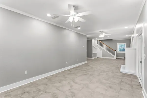 a kitchen with stainless steel appliances granite countertop a stove top oven a sink dishwasher a refrigerator and a dining table with wooden cabinet