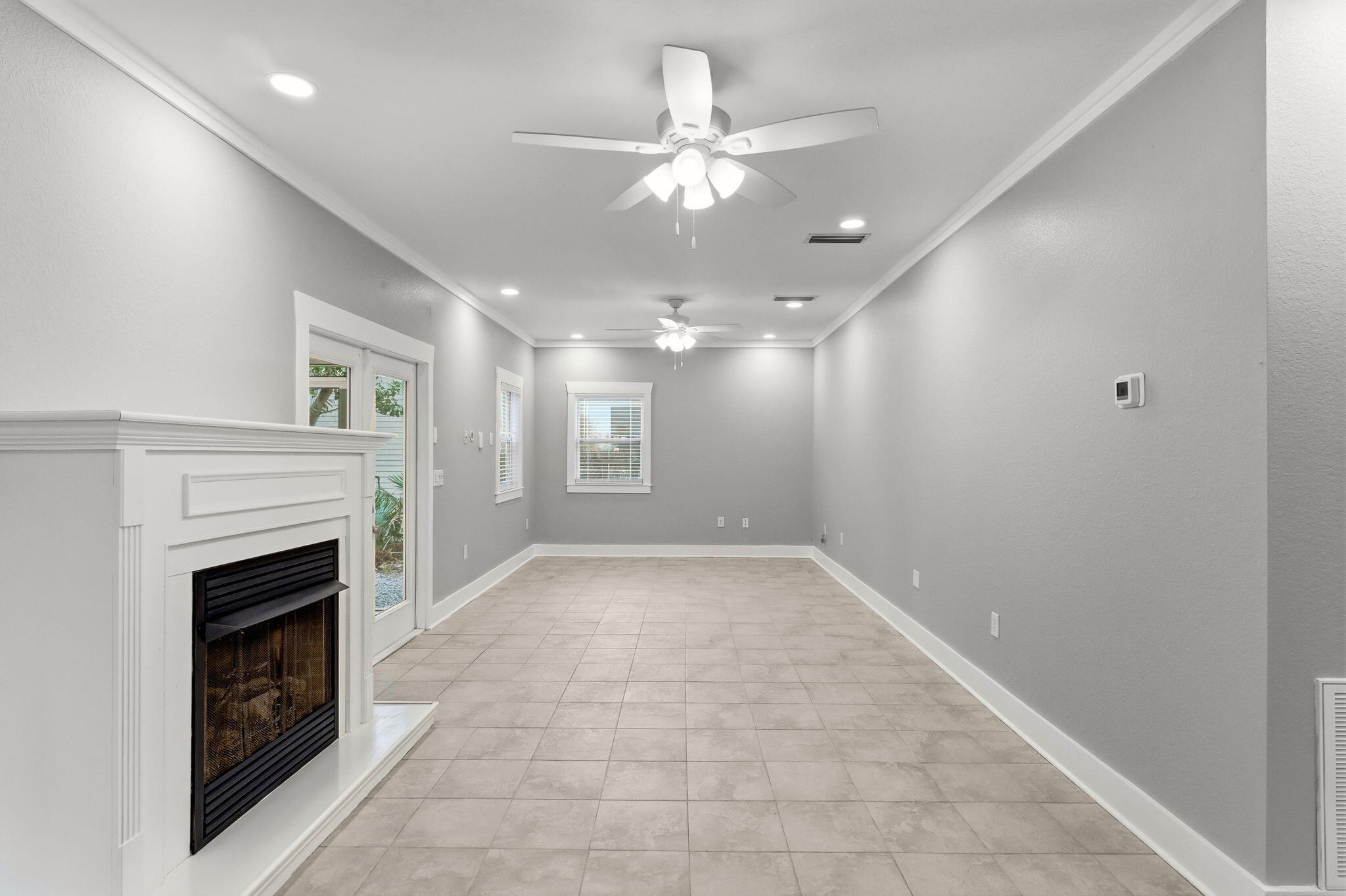 128 Bay Magnolia Lane Santa Rosa Beach, FL 32459 - Photo 17 of 61 a view of a livingroom with a ceiling fan fireplace and a window