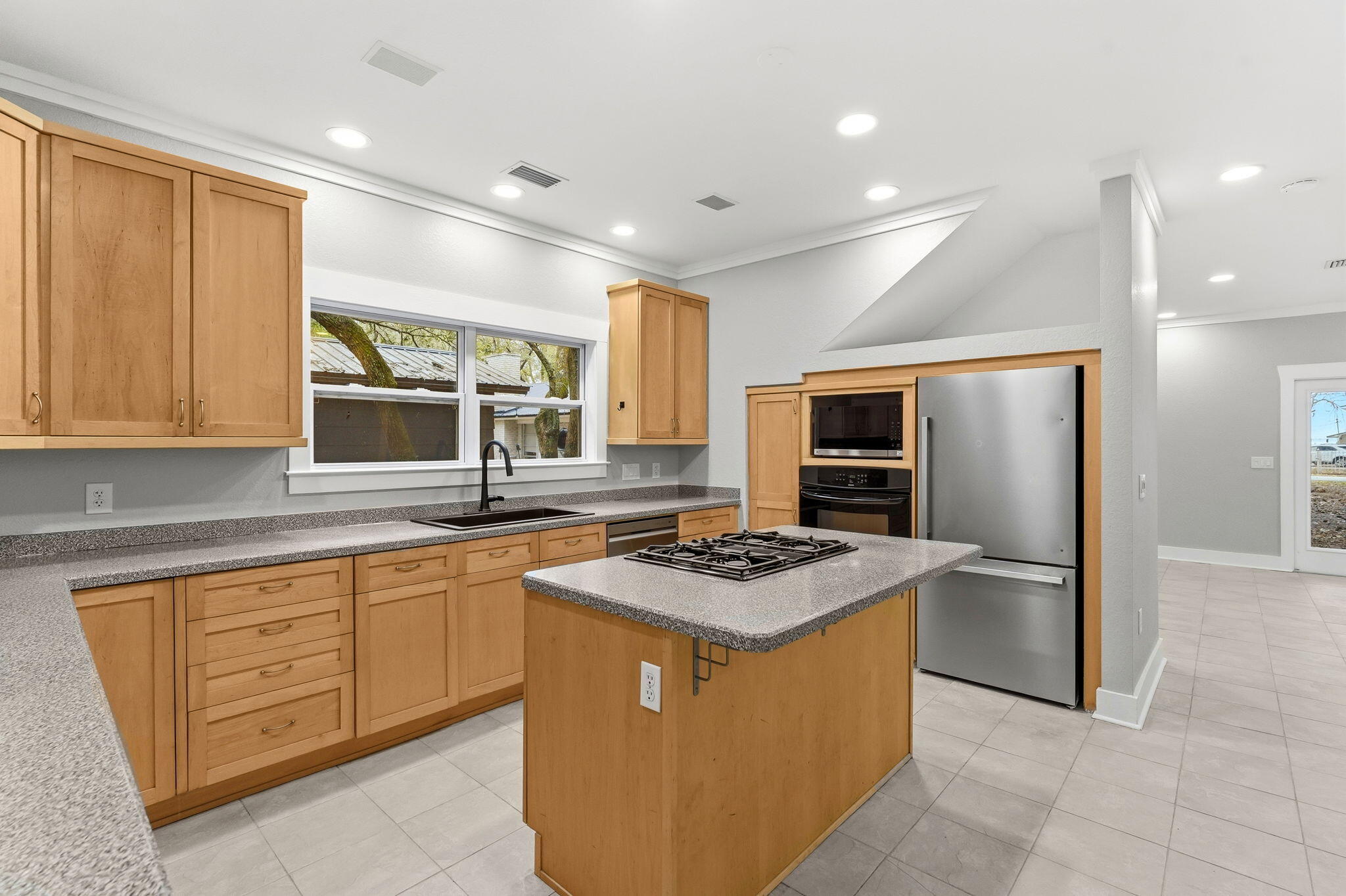 128 Bay Magnolia Lane Santa Rosa Beach, FL 32459 - Photo 19 of 61 a kitchen with stainless steel appliances granite countertop a stove top oven a sink dishwasher a refrigerator and a dining table with wooden cabinet