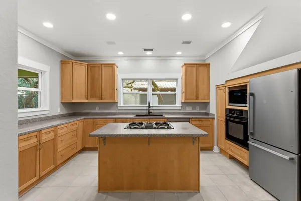 a kitchen with stainless steel appliances granite countertop a sink and a stove