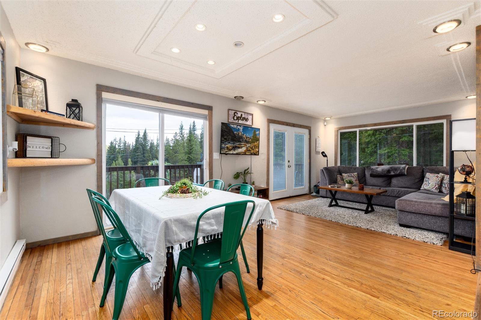 159 Lake Road Idaho Springs, CO 80452 - Photo 7 of 45 a view of a dining room with furniture window and wooden floor