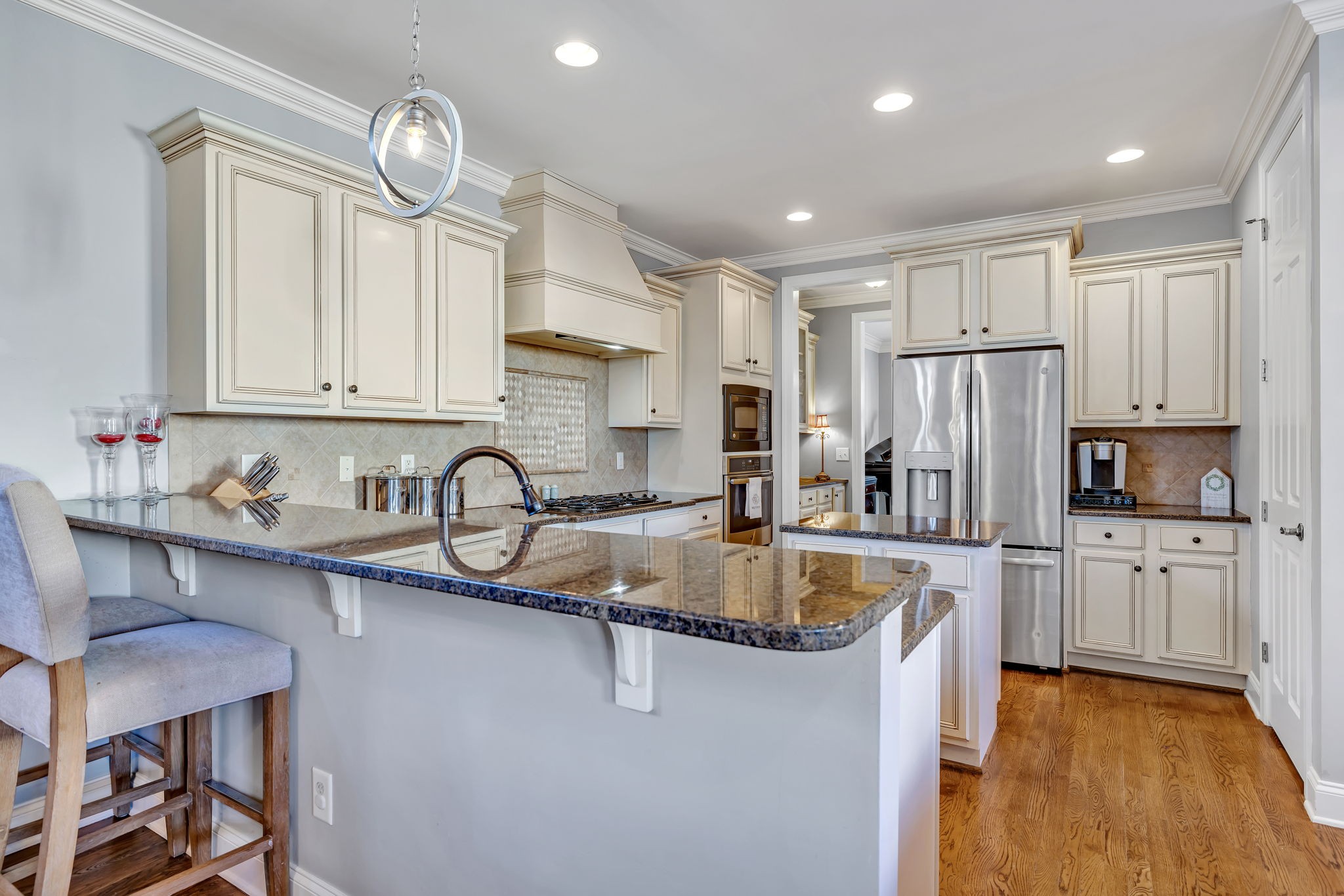1302 Jewell Avenue Franklin, TN 37064 - Photo 27 of 68 a kitchen with stainless steel appliances granite countertop a sink dishwasher a refrigerator and wooden cabinets with wooden floor