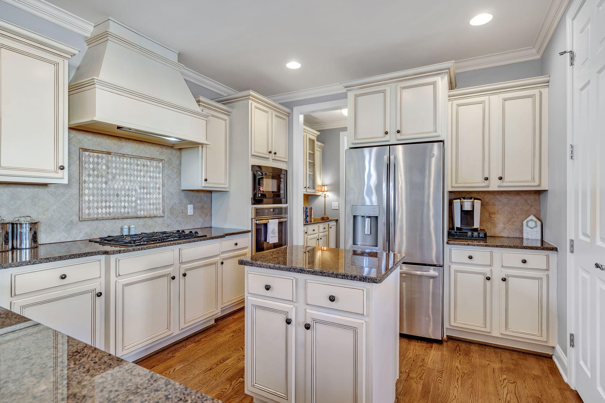 1302 Jewell Avenue Franklin, TN 37064 - Photo 28 of 68 a kitchen with white cabinets and stainless steel appliances
