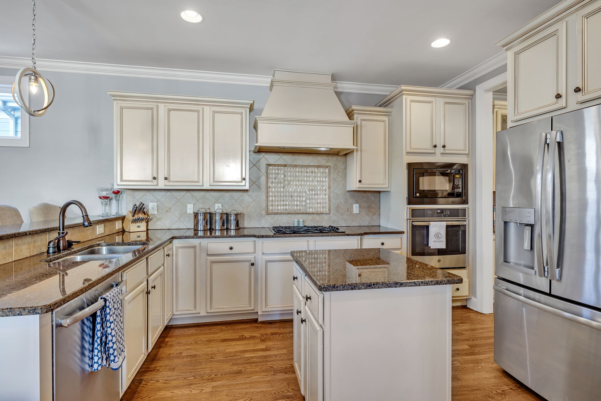 1302 Jewell Avenue Franklin, TN 37064 - Photo 29 of 68 a kitchen with stainless steel appliances granite countertop a sink stove refrigerator and cabinets