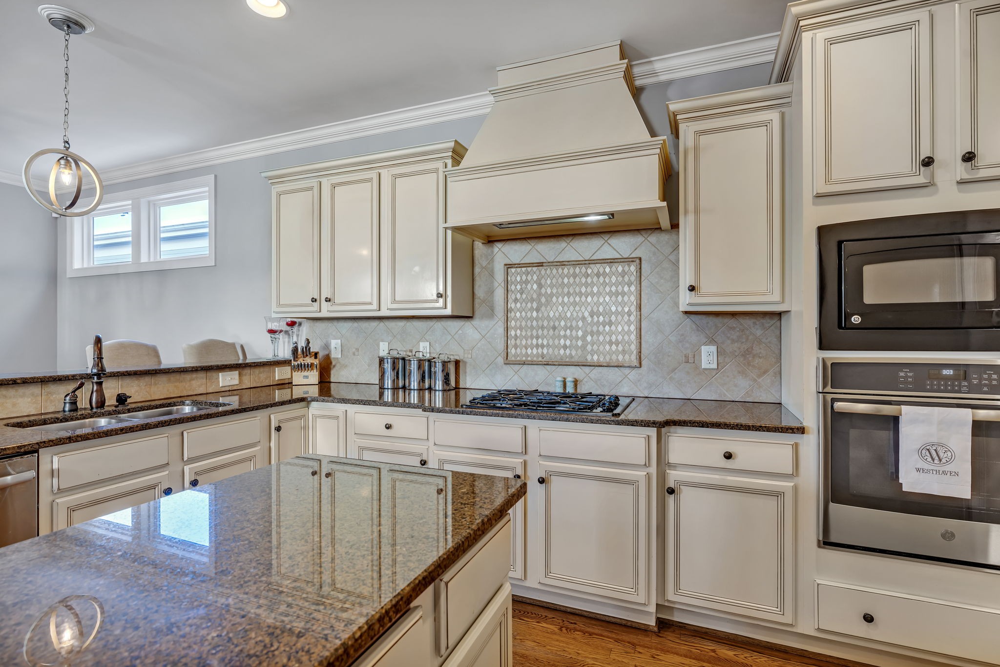 1302 Jewell Avenue Franklin, TN 37064 - Photo 30 of 68 a kitchen with granite countertop a sink a stove and cabinets