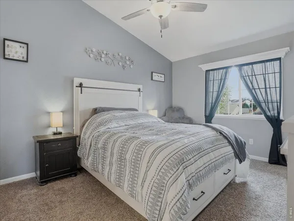 a spacious bedroom with a bed and a window