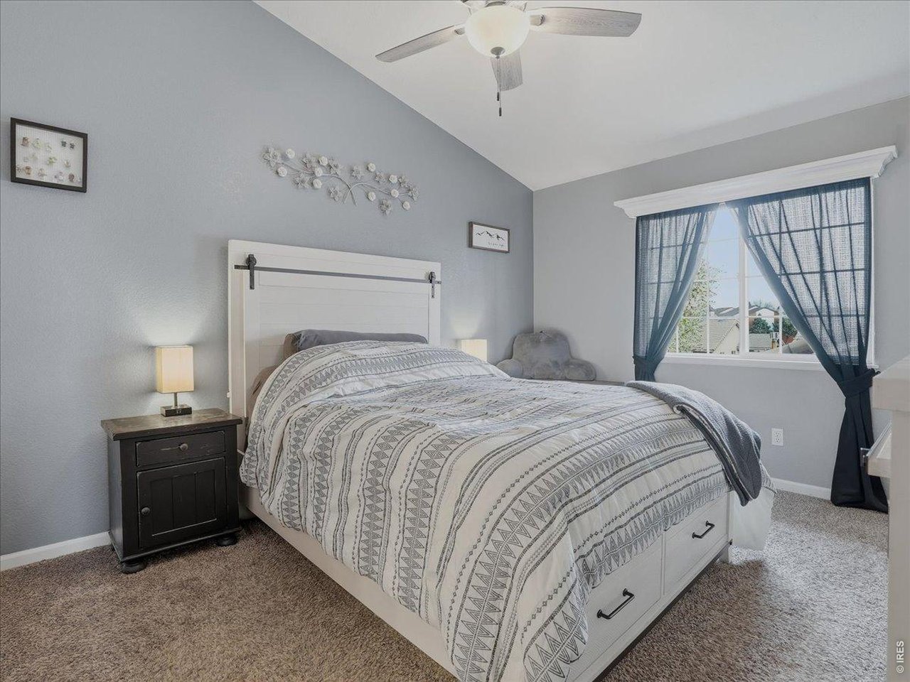5207 West 11th Street Road Greeley, CO 80634 - Photo 21 of 38 Primary bedroom with vaulted ceilings, walk-in closet and full bathroom