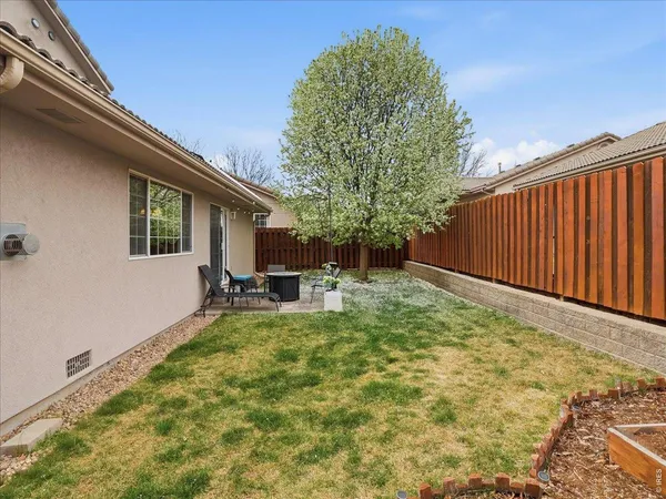 a view of backyard with a table and chairs