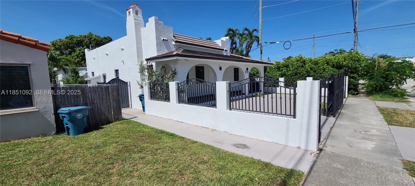 1721 Southwest 24th Terrace Miami, FL 33145 - Photo 75 of 80 a view of a house with a small yard and wooden fence