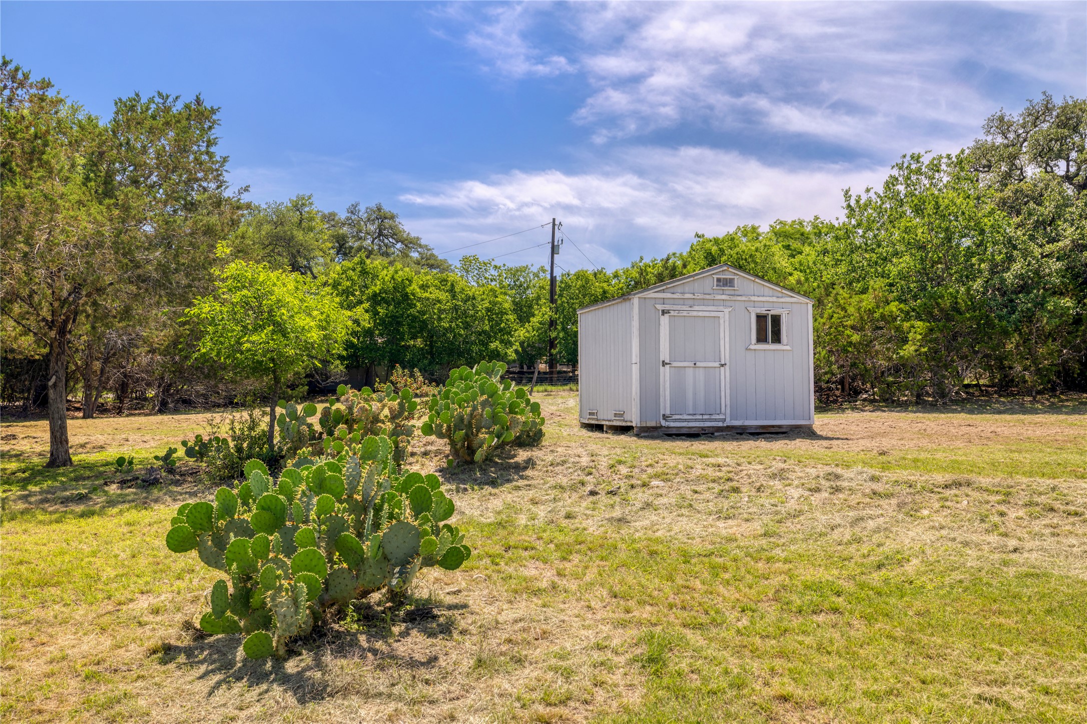 187 Beauchamp Road Dripping Springs, TX 78620 - Photo 7 of 19 Outdoor storage shed with a single window and gable roof