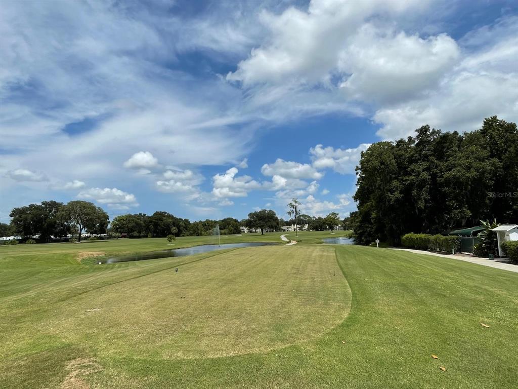 415 South Timber Trail Wildwood, FL 34785 - Photo 51 of 52 a view of a golf course with a lake