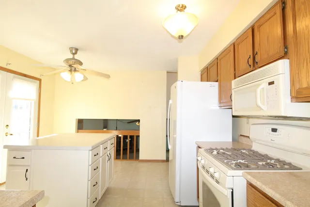 a kitchen with a stove a sink and a refrigerator