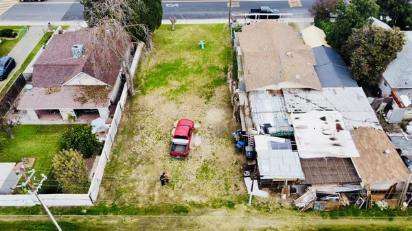 an aerial view of a house with a yard and potted plants