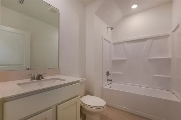 a bathroom with a sink toilet vanity and shower