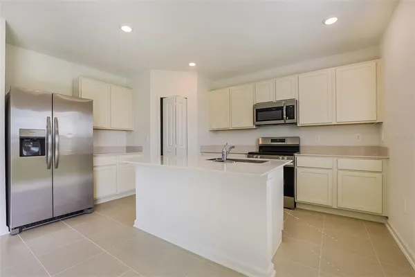 a kitchen with cabinets and stainless steel appliances