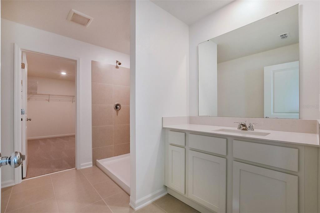 3608 Rolling Rdg Bend Davenport, FL 33837 - Photo 7 of 21 a bathroom with a tub sink and mirror