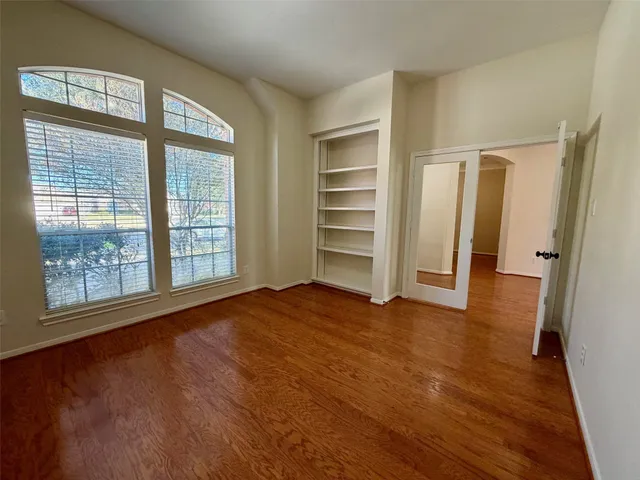 wooden floor in an empty room with a window