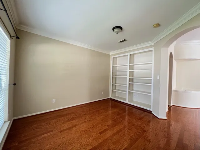 a view of a room with wooden floor and white walls